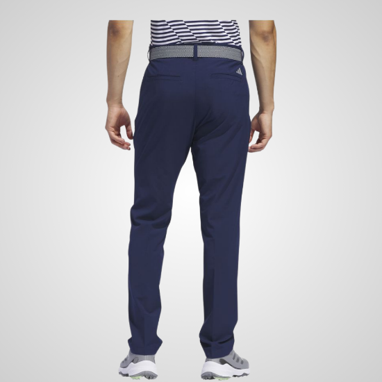 Model wearing adidas Men's Ultimate 365 Tapered Collegiate Navy Golf Pants Back View