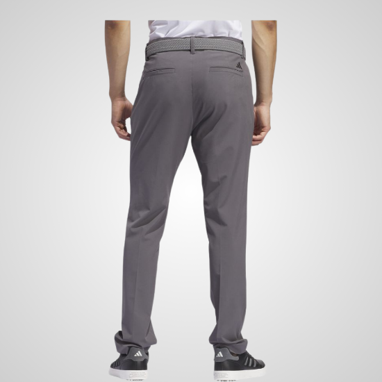 Model wearing adidas Men's Ultimate 365 Tapered Grey Five Golf Pants Back View